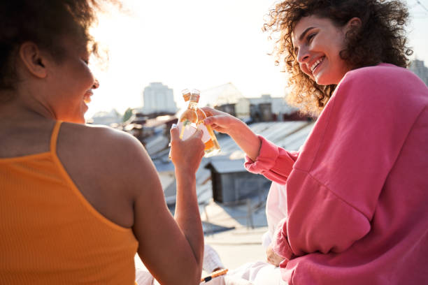 istock Joyful young women having fun with drinks outdoors 1265724428