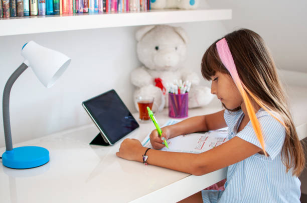 istock Cute girl online education at home 1265725789