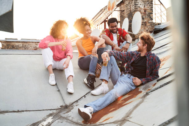 istock Cheerful young people having fun on roof 1265725970