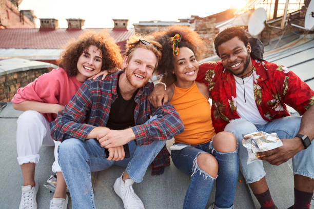 istock Smiling friends having good time together on urban roof 1265725982