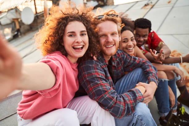 istock Happy friends spendingh good time on roof 1265725984