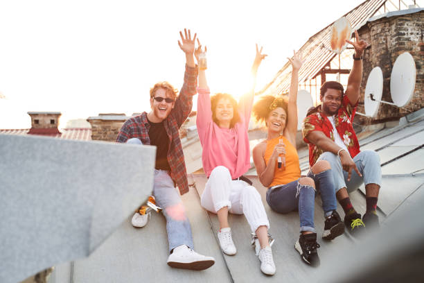 istock Two happy couples with bottles of drinks outdoors 1265725985