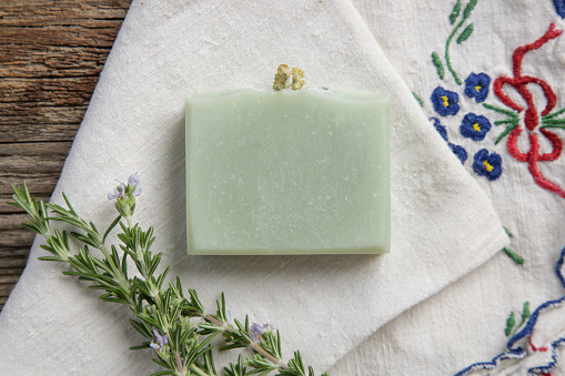 Rosemary handmade soap bar sensitive skin, close up. Homemade toxic-free natural organic cosmetic.