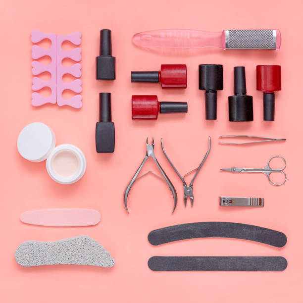 istock Manicure and pedicure accessories on pink background. Nail tools, polish, files, scissors, clippers 1265734997