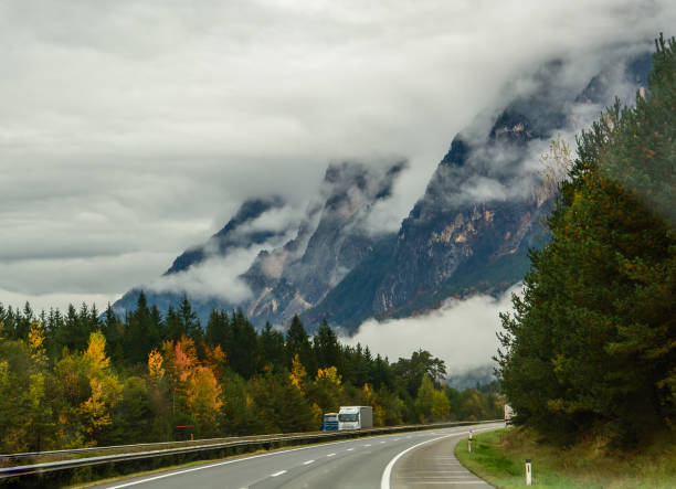 istock The road in the mountains. Alps.Mountains in the clouds 1265740949