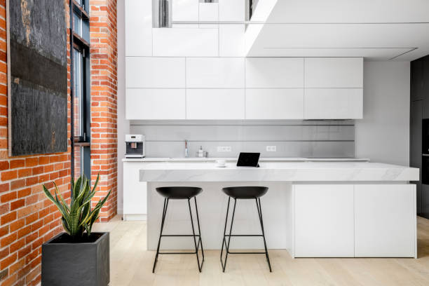 istock Elegant white kitchen with industrial style wall 1265741082