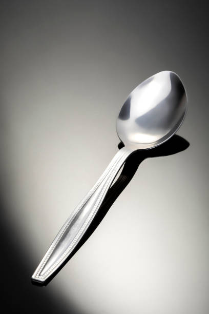istock Traditional metal spoon on dark and bright background. 1265756827