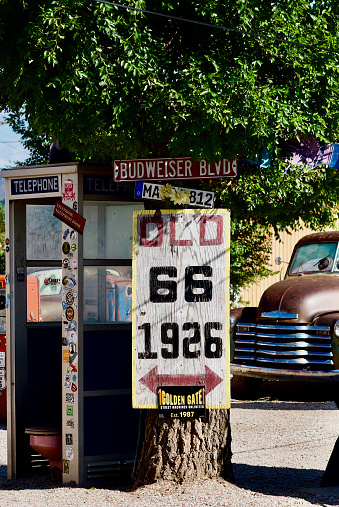 Seligman, Arizona, USA - July 30, 2020: An old telephone booth is one many unique items at Delgadillo’s Snow Cap drive-in, an iconic landmark along historic Route 66 in the heart of Seligman, Arizona.