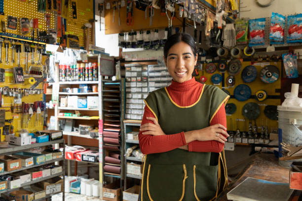 Smiling  worker attending a hardware store. stock photo