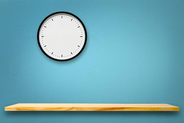 istock Blank wall clock above the wooden shelf 1265796869
