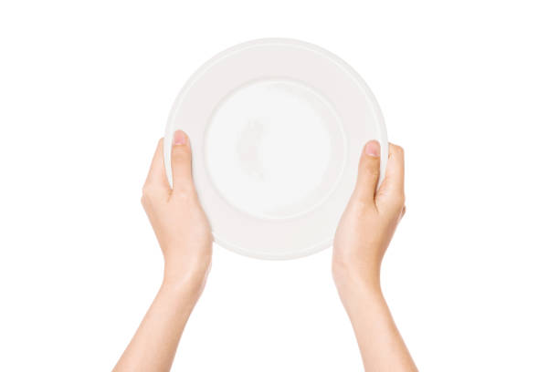 istock woman hand hold a white dish horizontal isolated on white. 1265798362