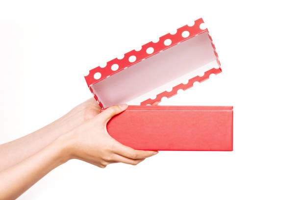 istock woman hand hold a red dotting box and open isolated on white. 1265798455