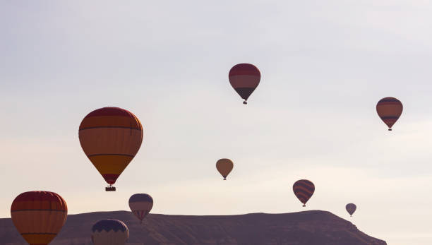 istock Hot air balloons profiled on clear blue sky, in Cappadocia, Turkey 1265807047