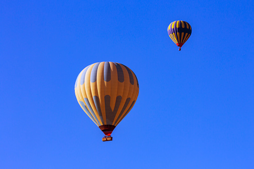 Two balloons float overhead in Boise Idaho