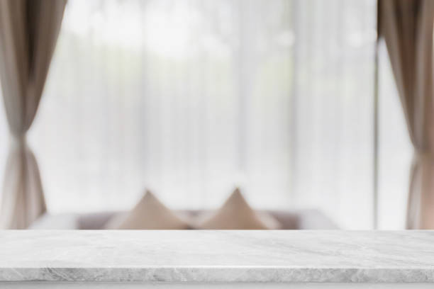 istock Empty white marble stone table top and blurred living room in home interior with curtain window background. - can used for display or montage your products. 1265820815