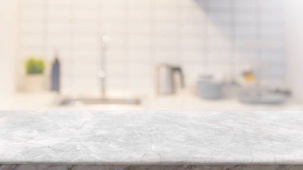 istock Empty white marble stone table top and blurred kitchen interior banner background - can used for display or montage your products. 1265820819