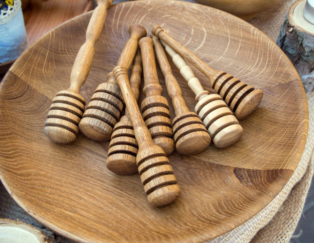 istock Spoon sticks for honey lie on a wooden dish 1265838691