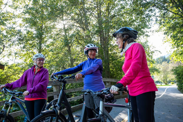 istock Three active senior woman enjoy riding their bicycles 1265855091