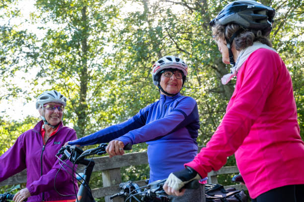 istock Three active senior woman enjoy riding their bicycles 1265855604