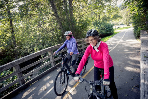 istock Three women enjoy riding their bicycles together 1265856632