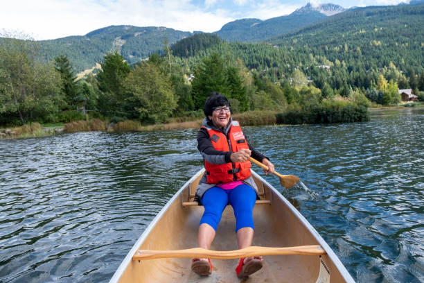 istock Active senior woman paddling on a lake 1265862149