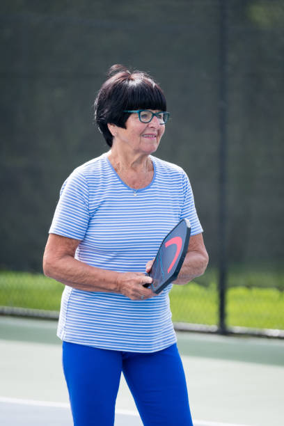 istock Active senior playing pickleball at a public court 1265862206