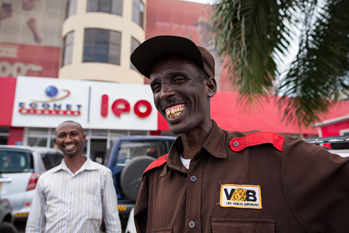 Bujumbura / Burundi - October 15, 2016: Portrait of smiling black security guard in uniform working on a bank in the capital