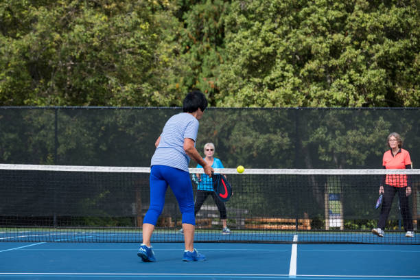 istock Active seniors playing pickleball on the public court 1265862363