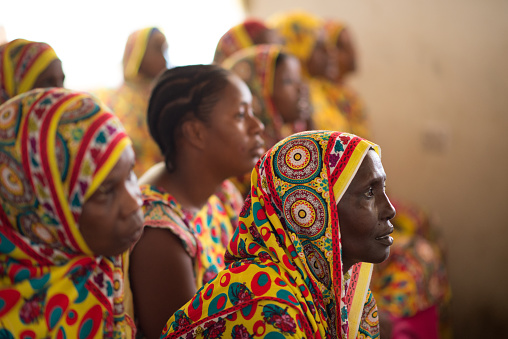 Lamu, Kenya - December 15, 2016: African women wearing colorful clothes attend a meeting