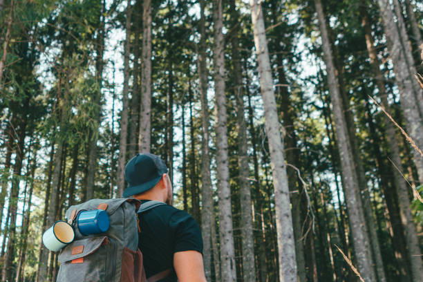 istock man with backpack walking by stone stairs that leads to the forest 1265898859