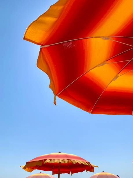 istock colorful umbrellas with beautiful blue sky 1265912401
