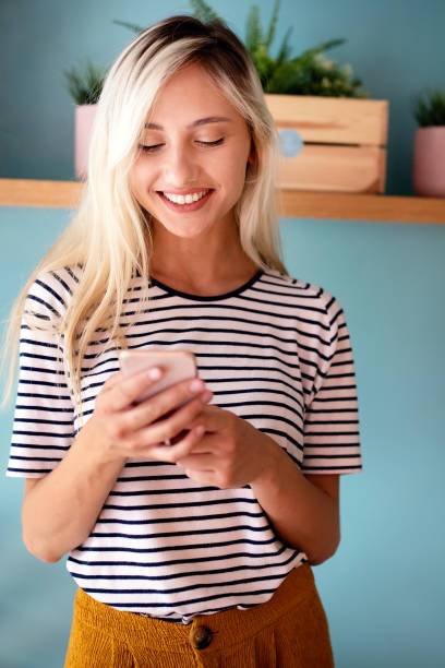 istock Young beautiful women touching and browsing her smart phone 1265915817