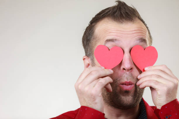 istock Man in love with hearts on eyes 1265923883