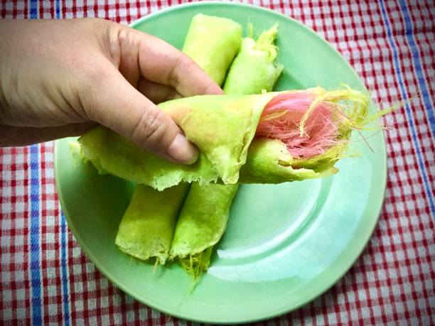 istock Hand Holding Chapati Roti, Paratha or Crepe with Cotton Candy 1265924436