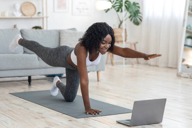 istock Attractive black woman making morning exercise at home 1265925525