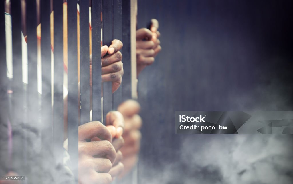 tear gas thrown to the protesters tear gas thrown to the protesters behind bars Crowded Stock Photo