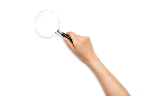 Magnifying glass in child hand on white background, isolate