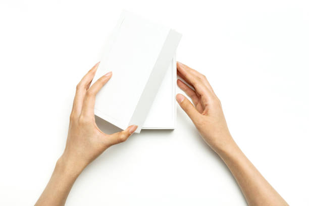 istock woman hand hold a white package box isolated on white. 1265935279