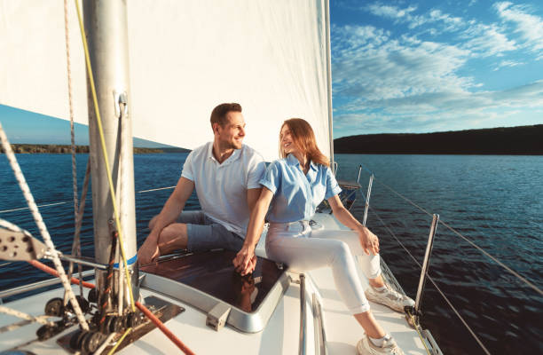 istock Couple Holding Hands Enjoying Yacht Ride Spending Vacation On River 1265935367