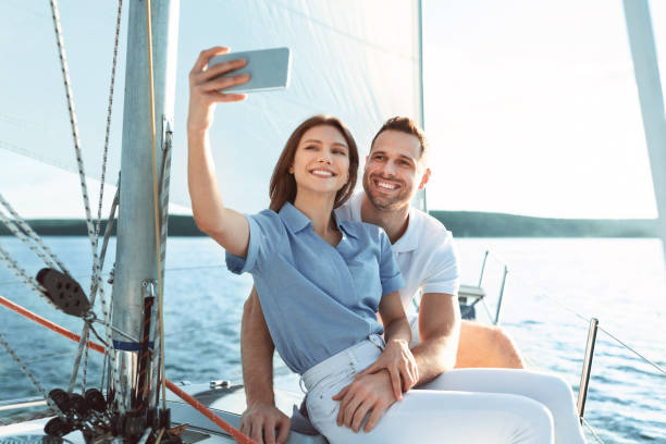 istock Couple Having Ride On Yacht Making Selfie At Seaside 1265935825