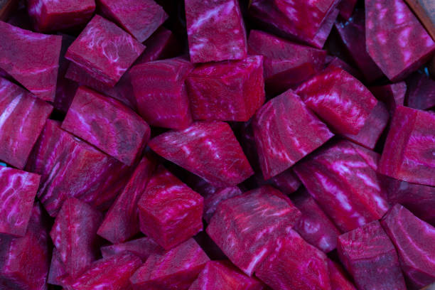 istock Fresh segments of a red beetroot, closeup. Purple beet slices background, top view 1265941242
