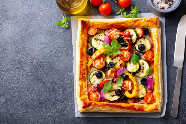 istock Puff pastry pizza with grilled vegetables. Grey background. Copy space. Top view. 1265941655