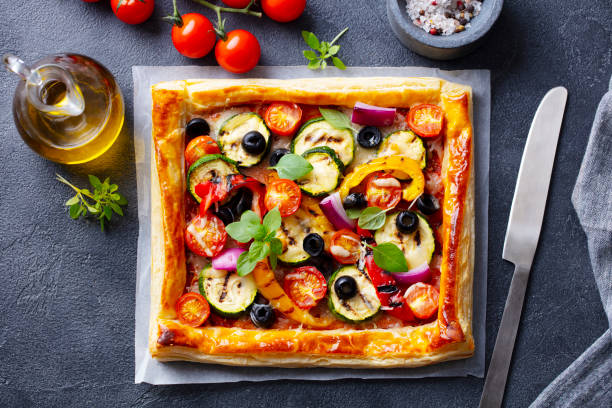 istock Puff pastry pizza with grilled vegetables. Grey background. Close up. Top view. 1265941697