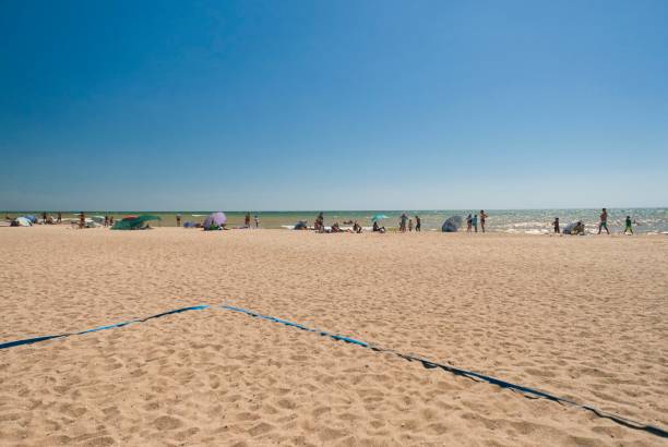 istock people sunbathe by the sea 1265941784