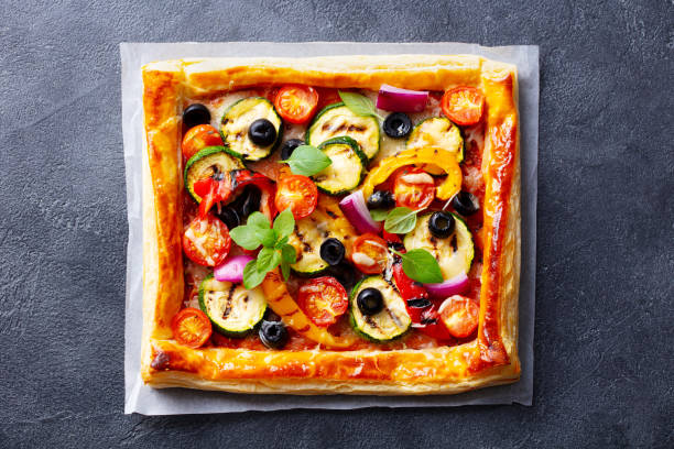 istock Puff pastry pizza with grilled vegetables. Grey background. Close up. Top view. 1265942342