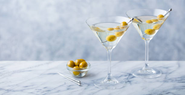 istock Martini cocktail with green olives on marble table background. Copy space. Close up. 1265944705