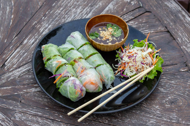 istock Fresh vietnamese spring rolls on a plate with salad, closeup 1265944737