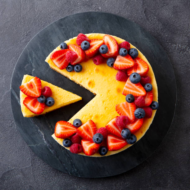 Cheesecake dessert with fresh berries. Gray background. Close up. Top view.