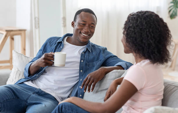 istock Lovely african couple drinking tea and having conversation 1265949676