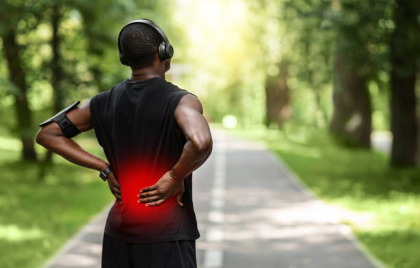 istock Black sportsman touching sore zone on his back 1265949976